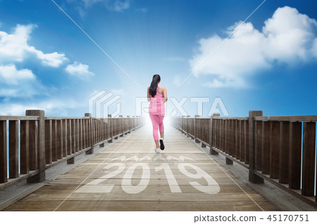 Rear view of woman running into new year of 2019 45170751