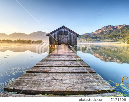 Beautiful lake with traditional wooden boat house. Beautiful lake with traditional wooden boat house. 45171806