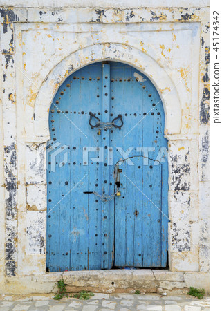 Aged Blue door in Andalusian style Sidi Bou Said 45174342