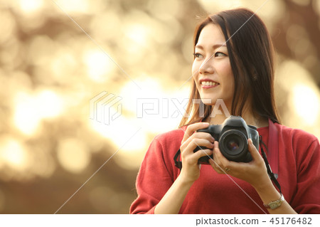 A woman taking a picture A woman taking a picture 45176482