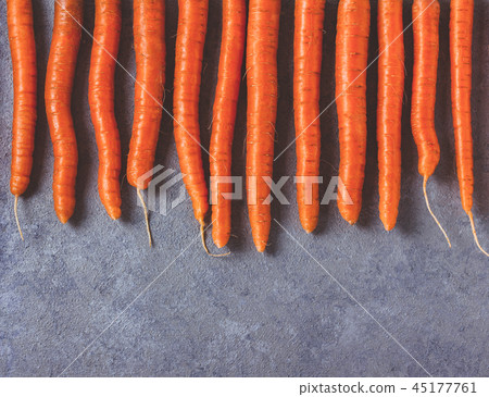 Raw fresh carrots on gray beton background. Raw fresh carrots on gray beton background. 45177761