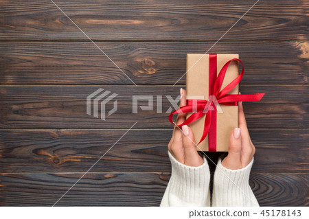 Woman hands give wrapped valentine or holiday 45178143