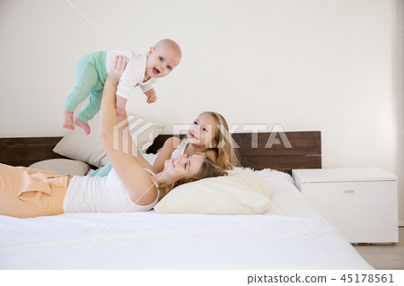 three girls sisters in the play in the bedroom in the morning love 45178561
