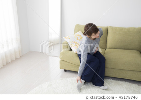 A woman whose legs are hanging A woman whose legs are hanging 45178746