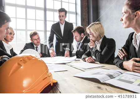 Business people with construction blueprint Business people with construction blueprint 45178931