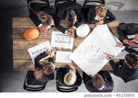 Business people with construction blueprint 45178950