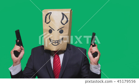 concept of emotion, gestures. a man with a package on his head, with a painted smiley angry, sly 45179556