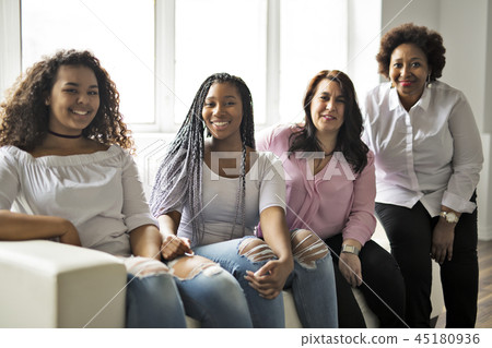 Two family Friends Sitting On Sofa Together Two family Friends Sitting On Sofa Together 45180936