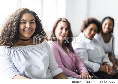 Two family Friends Sitting On Sofa Together Two family Friends Sitting On Sofa Together 45180939