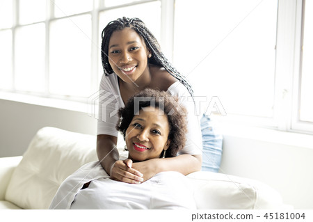 affectionate mother and daughter sitting on sofa affectionate mother and daughter sitting on sofa 45181004