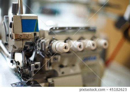 closeup details on sewing machine overlock. Workplace seamstress.Tailoring industry closeup details on sewing machine overlock. Workplace seamstress.Tailoring industry 45182623