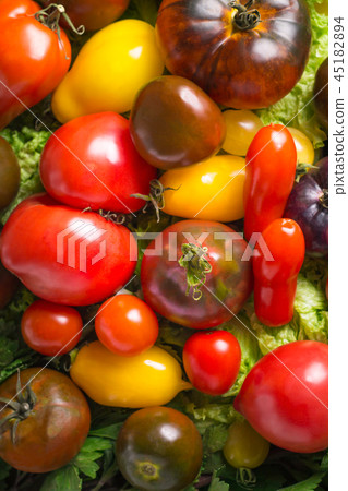Fresh heirloom tomatoes colorfull background Fresh heirloom tomatoes colorfull background 45182894