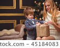 Mom and son near the Christmas tree 45184083