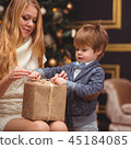 Mom and son near the Christmas tree 45184085