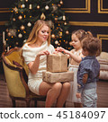 Mom and her children near the Christmas tree 45184097