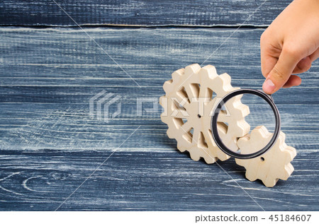 Magnifying glass is looking at the Gears of wood 45184607
