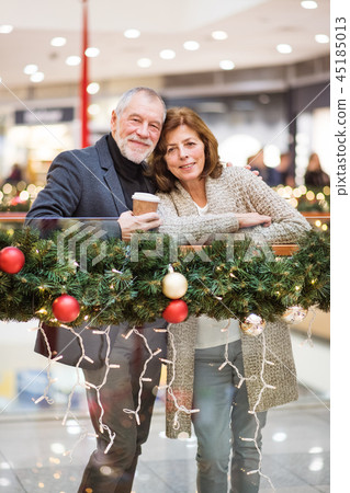 A happy senior couple doing Christmas shopping. A happy senior couple doing Christmas shopping. 45185013