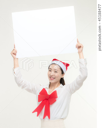 Christmas Day. Korea woman holding a white card Christmas Day. Korea woman holding a white card 45188477