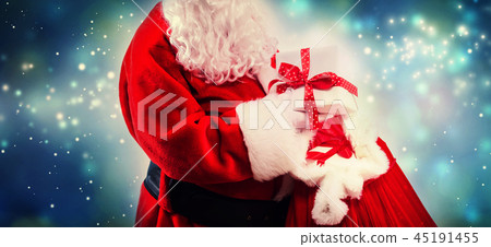 Santa holding a present box from a red sack Santa holding a present box from a red sack 45191455