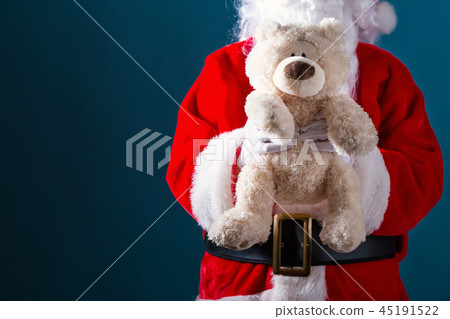 Santa holding a teddy bear Santa holding a teddy bear 45191522