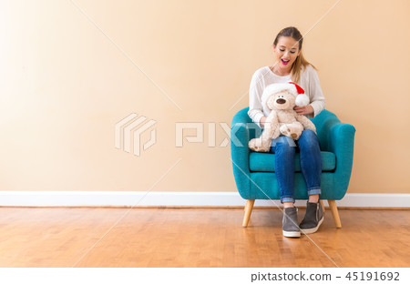 Young woman holding a teddy bear 45191692
