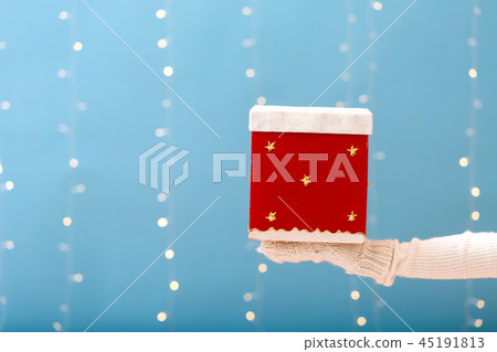 Person holding a Christmas gift box Person holding a Christmas gift box 45191813