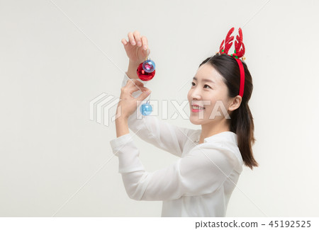 Christmas Day. Korea woman holding xmas props Christmas Day. Korea woman holding xmas props 45192525