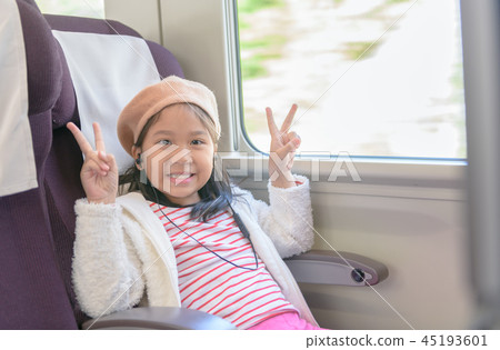 Little traveler listening music from earphone 45193601