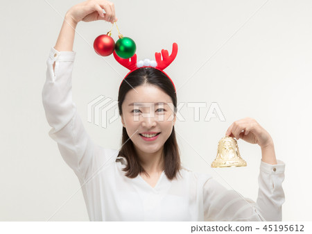 Christmas Day. Korea woman holding xmas props Christmas Day. Korea woman holding xmas props 45195612