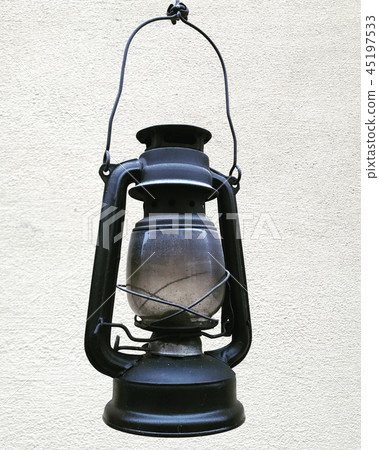 Kerosene lamp hanging on a background of gray wall Kerosene lamp hanging on a background of gray wall 45197533
