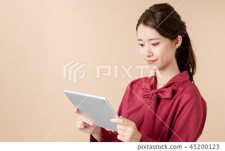 A woman using a tablet 45200123