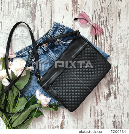 Black bag with shorts on a wooden background Black bag with shorts on a wooden background 45200384