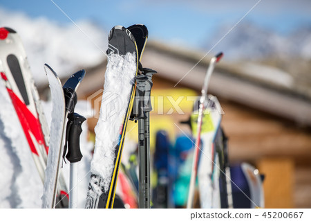 Image of multi-colored skis in snow at winter resort in afternoon. 45200667