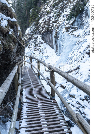 A narrow gorge covered with snow and ice. 45200753