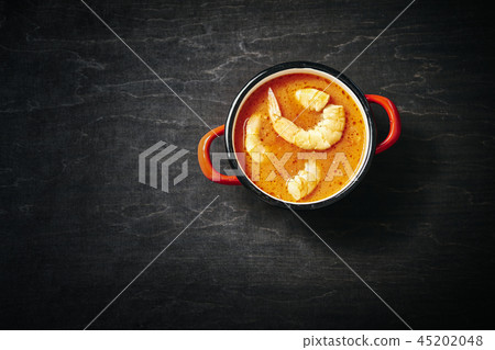 traditional Thai soup with shrimp in a red pot traditional Thai soup with shrimp in a red pot 45202048