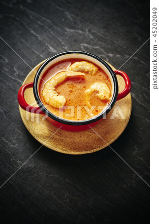 traditional Thai soup with shrimp in a red pot traditional Thai soup with shrimp in a red pot 45202049