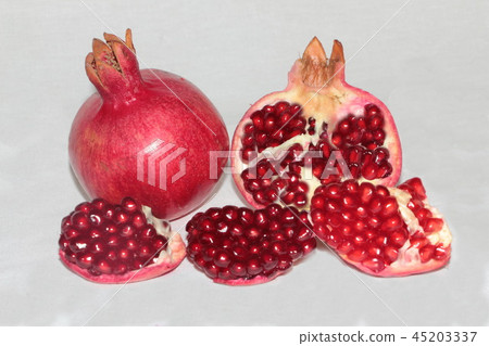 ripe, red pomegranates grown in the garden ripe, red pomegranates grown in the garden 45203337