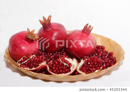 ripe, red pomegranates grown in the garden ripe, red pomegranates grown in the garden 45203344