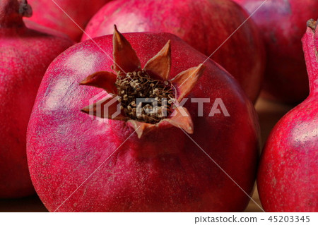 ripe, red pomegranates grown in the garden ripe, red pomegranates grown in the garden 45203345
