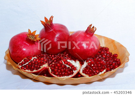 ripe, red pomegranates grown in the garden ripe, red pomegranates grown in the garden 45203346