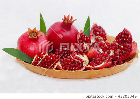 ripe, red pomegranates grown in the garden ripe, red pomegranates grown in the garden 45203349