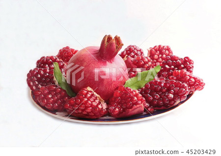 ripe, red pomegranates grown in the garden ripe, red pomegranates grown in the garden 45203429