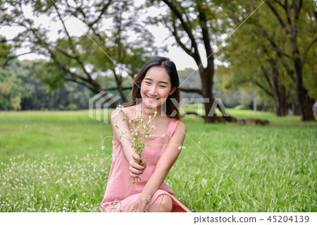 Holiday concept. Beautiful girl is getting flowers. Beautiful gi 45204139