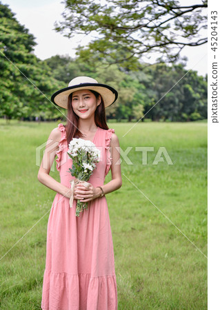 Holiday concept. Beautiful girl is getting flowers. Beautiful gi 45204143