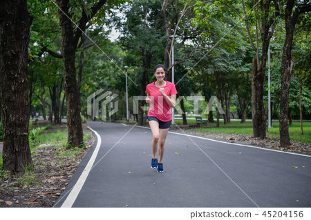 Exercise concept. Athletic girl exercising within the park. Beau 45204156