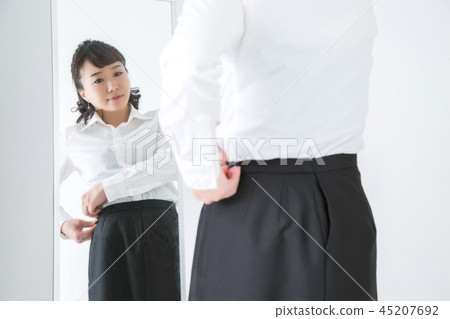 Woman closing fastener 45207692