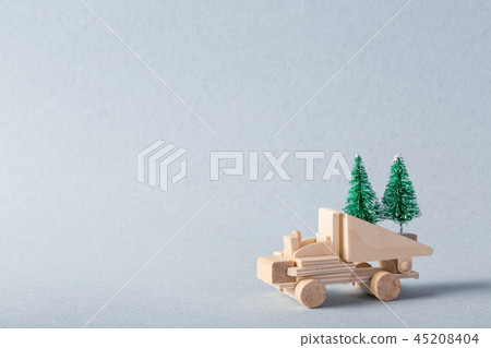 Miniature wooden truck with x-mas tree on is top 45208404
