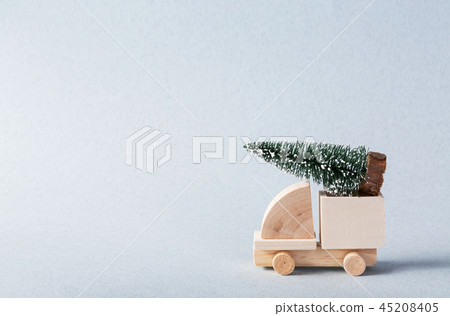 Miniature wooden truck with x-mas tree on is top 45208405