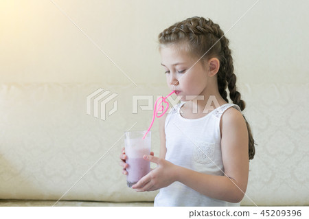A child drinks a cocktail through a straw. 45209396