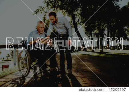 Smiling Man Hold Tablet. Outdoor Rehabilitation. Smiling Man Hold Tablet. Outdoor Rehabilitation. 45209597